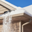 contractor working on removing snow from roof in minnesota winter